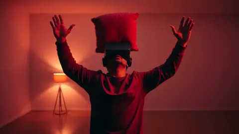 Player in a headset recoiling from a jump scare in a cleared room