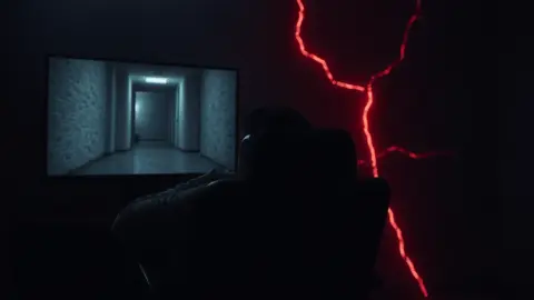 Gamer slouched at a monitor while a red crack spreads across the wall behind the chair