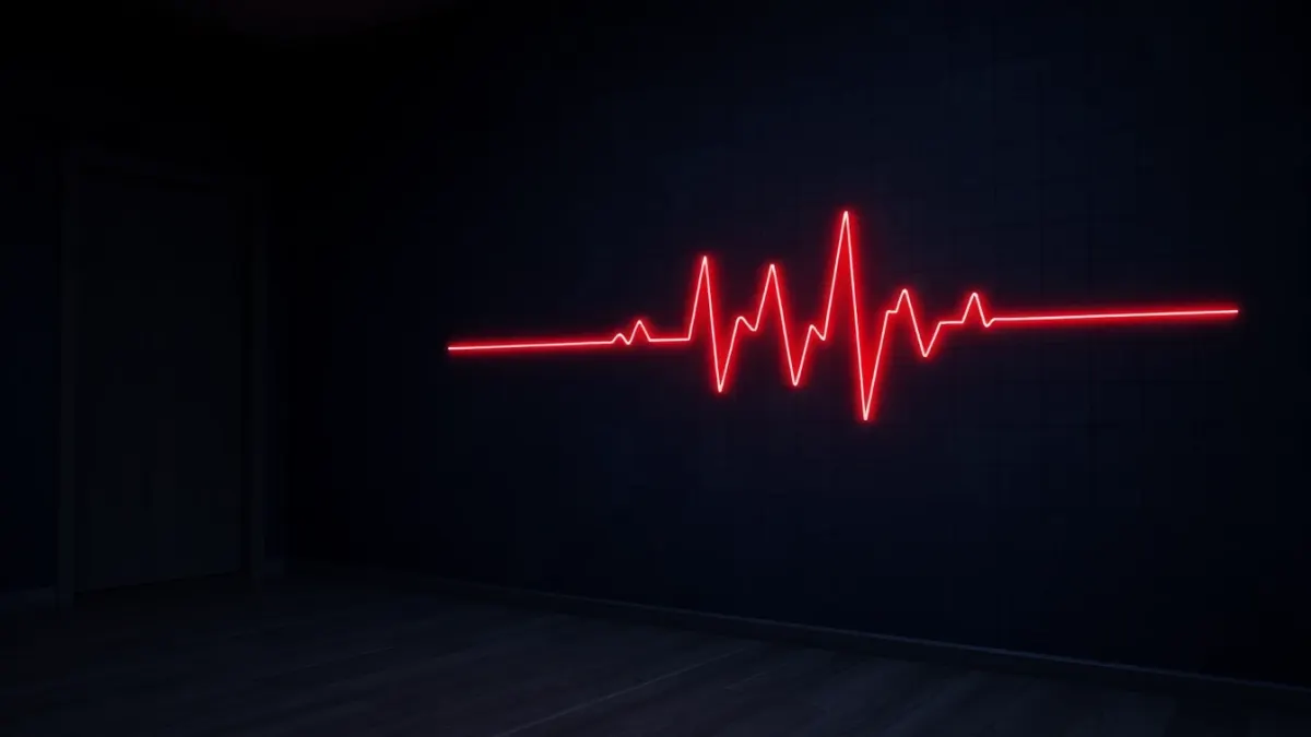 Glowing red heartbeat-style line on a dark wall in a dim room
