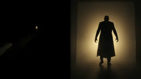 Quiet candlelit dark room next to the same room in a sudden flash with a looming silhouette