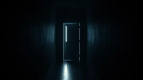 Dim home hallway with a half-open door at the far end and a faint figure in the shadow