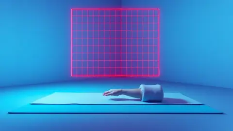 Padded knee and hand crouching on a mat beneath a low red laser grid
