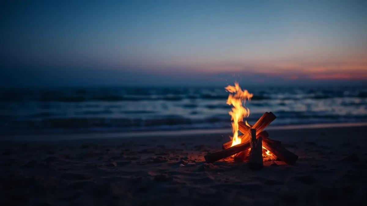 Small steady campfire on a beach at dusk, symbolizing a sustained streak
