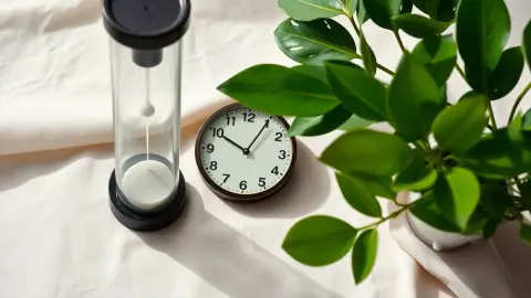 Hourglass and clock on linen, symbolizing short and long meditation sessions