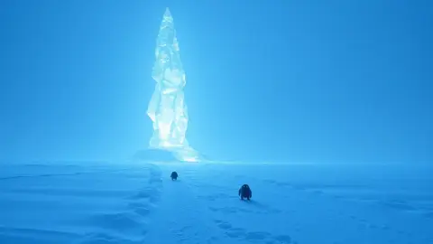 A glowing ice spire tower slowing monsters on a snowy path